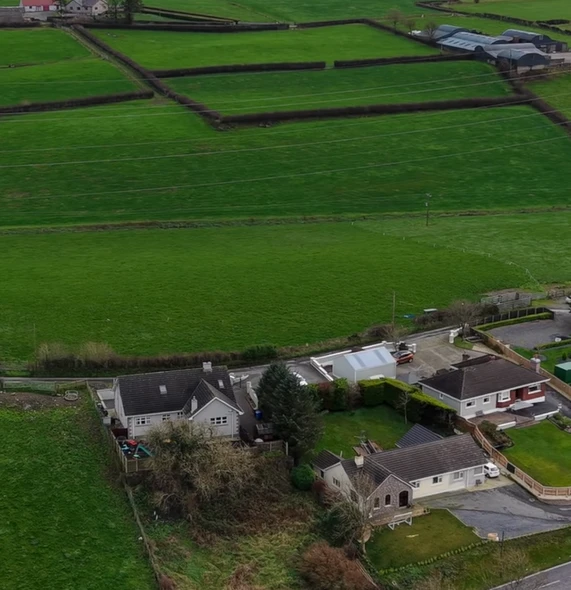 Aerial view of homes and farmland, from the Planning Permission Experts video ad